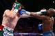 LAS VEGAS, NV - SEPTEMBER 14: (L-R) Floyd Mayweather Jr. and Canelo Alvarez exchange punches during their WBC/WBA 154-pound title fight at the MGM Grand Garden Arena on September 14, 2013 in Las Vegas, Nevada. (Photo by Al Bello/Getty Images)
