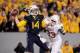 Nov 9, 2013; Morgantown, WV, USA; West Virginia Mountaineers quarterback Paul Millard (14) throws the ball while getting pressured by Texas Longhorns linebacker Steve Edmond (33) at Milan Puskar Stadium. Mandatory Credit: Evan Habeeb-USA TODAY Sports