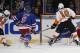 Jason Akeson, far left, puts home rebound.