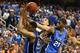 GREENSBORO, NC - MARCH 16: Anthony Gill #13 of the Virginia Cavaliers and Amile Jefferson #21 and Jabari Parker #1 of the Duke Blue Devils go for the ball during the finals of the 2014 Men's ACC Basketball Tournament at Greensboro Coliseum on March 16, 2
