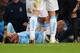 MANCHESTER, ENGLAND - APRIL 21: An injured David Silva of Manchester City is given treatment during the Barclays Premier League match between Manchester City and West Bromwich Albion at Etihad Stadium on April 21, 2014 in Manchester, England. (Photo by