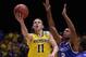 INDIANAPOLIS, IN - MARCH 30: Nik Stauskas #11 of the Michigan Wolverines shoots the ball against Aaron Harrison #2 of the Kentucky Wildcats during the midwest regional final of the 2014 NCAA Men's Basketball Tournament at Lucas Oil Stadium on March 30, 2