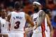 Mar 12, 2014; Miami, FL, USA; Miami Heat forward LeBron James (right) greets teammate Dwyane Wade (left) during the first half against the Brooklyn Nets at American Airlines Arena. Mandatory Credit: Steve Mitchell-USA TODAY Sports