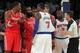 Nov 14, 2013; New York, NY, USA; New York Knicks small forward Carmelo Anthony (7) is restrained by official Scott Foster (48) as he confronts Houston Rockets power forward Dwight Howard (12) and shooting guard James Harden (13) during the third quarter o