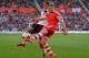 SOUTHAMPTON, ENGLAND - MARCH 15: Luke Shaw of Southampton clears the ball away from Johan Elmander of Norwich during the Barclays Premier League match between Southampton and Norwich City at St Mary's Stadium on March 15, 2014 in Southampton, England. (