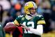 GREEN BAY, WI - JANUARY 05: Aaron Rodgers #12 of the Green Bay Packers looks to throw a pass during warm ups prior to their NFC Wild Card Playoff game against the San Francisco 49ers at Lambeau Field on January 5, 2014 in Green Bay, Wisconsin. (Photo by