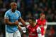 MANCHESTER, ENGLAND - DECEMBER 14: Vincent Kompany of Manchester City helps Thomas Vermaelen of Arsenal to his feet during the Barclays Premier League match between Manchester City and Arsenal at Etihad Stadium on December 14, 2013 in Manchester, England.