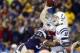 Jan 11, 2014; Foxborough, MA, USA; Indianapolis Colts quarterback Andrew Luck (12) is hit by New England Patriots outside linebacker Jamie Collins (91) in the first half during the 2013 AFC divisional playoff football game at Gillette Stadium. Mandatory C