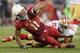 GLENDALE, AZ - DECEMBER 29: Wide receiver Larry Fitzgerald #11 of the Arizona Cardinals is tackled by free safety Eric Reid #35 of the San Francisco 49ers after a reception during the NFL game at the University of Phoenix Stadium on December 29, 2013 in