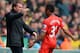 NORWICH, ENGLAND - APRIL 20: Raheem Sterling of Liverpool celebrates scoring the opening goal with Manager Brendan Rodgers of Liverpool during the Barclays Premier League match between Norwich City and Liverpool at Carrow Road on April 20, 2014 in Norwic