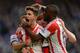 LONDON, ENGLAND - APRIL 19: Fabio Borini of Sunderland is mobbed by team mates after scoring the winner from the penalty spot during the Barclays Premier League match between Chelsea and Sunderland at Stamford Bridge on April 19, 2014 in London, England.