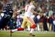 SEATTLE, WA - JANUARY 19: Quarterback Colin Kaepernick #7 of the San Francisco 49ers scrambles as defensive end Michael Bennett #72 of the Seattle Seahawks defends during the 2014 NFC Championship at CenturyLink Field on January 19, 2014 in Seattle, Washi