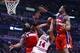 Apr 22, 2014; Chicago, IL, USA; Chicago Bulls guard D.J. Augustin (14) shoots the ball against Washington Wizards forward Nene Hilario (42) and guard Bradley Beal (3) during the second half in game two during the first round of the 2014 NBA Playoffs at Un