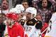 DETROIT, MI - APRIL 24: Drew Miller #20 of the Detroit Red Wings skates away as members of the Boston Bruins celebrate with teammate Jarome Iginla #12 after scoring the game winning goal in overtime of Game Four of the First Round of the 2014 Stanley Cup