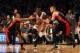 Apr 25, 2014; Brooklyn, NY, USA; Brooklyn Nets center Andray Blatche (0) drives between Toronto Raptors guard Kyle Lowry (7) and forward Amir Johnson (15) during the fourth quarter in game three of the first round of the 2014 NBA Playoffs at Barclays Cent