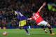 MANCHESTER, ENGLAND - JANUARY 05: Tom Cleverley of Manchester United grabs the shirt of Wilfried Bony of Swansea City during the FA Cup with Budweiser Third round match between Manchester United and Swansea City at Old Trafford on January 5, 2014 in Manc