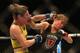 BRISBANE, AUSTRALIA - DECEMBER 07: Bethe Correia of Brazil and Julie Kedzie of the USA exchange punches during their women's bantamweight fight during the UFC Fight Night event atat Brisbane Entertainment Centre on December 7, 2013 in Brisbane, Australia