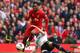 LIVERPOOL, ENGLAND - MARCH 30: Daniel Sturridge of Liverpool is challenged by Michael Dawson of Tottenham Hotspur during the Barclays Premier League match between Liverpool and Tottenham Hotspur at Anfield on March 30, 2014 in Liverpool, England. (Photo