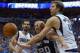 DALLAS, TX - APRIL 26: Manu Ginobili #20 of the San Antonio Spurs drives to the basket against Dirk Nowitzki #41 of the Dallas Mavericks and Jose Calderon #8 of the Dallas Mavericks during Game Three of the Western Conference Quarterfinals during the 201