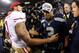 SEATTLE, WA - JANUARY 19: Quarterback Colin Kaepernick #7 of the San Francisco 49ers shakes hands with quarterback Russell Wilson #3 of the Seattle Seahawks after the Seahawks defeated the 49ers 23-17 during the 2014 NFC Championship at CenturyLink Field