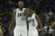 Mar 31, 2014; Charlotte, NC, USA; Charlotte Bobcats guard Kemba Walker (15) celebrates with center Al Jefferson (25) during the second half against the Washington Wizards at Time Warner Cable Arena. Bobcats defeated the Wizards 100-94. Mandatory Credit: J