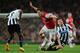 LONDON, ENGLAND - APRIL 28: Aaron Ramsey of Arsenal takes on Vurnon Anita (L) and Mathieu Debuchy of Newcastle United (R) during the Barclays Premier League match between Arsenal and Newcastle United at Emirates Stadium on April 28, 2014 in London, Engla