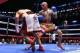 Jan 30, 2014; Brooklyn, NY, USA; Victor Ortiz (White/Red trunks) falls to the canvas after a right hook from Luis Collazo (Tan/Blue/Red trunks) during their bout at Barclays Center. Collazo won via 2nd round KO. Mandatory Credit: Ed Mulholland-USA TODAY