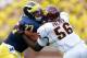 ANN ARBOR, MI - AUGUST 31: Taylor Lewan #77 of the Michigan Wolverines block the pass rush of Louis Palmer #56 of the Central Michigan Chippewas during the first quarter at Michigan Stadium on August 31, 2013 in Ann Arbor, Michigan. (Photo by Gregory Sha