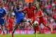 LIVERPOOL, ENGLAND - APRIL 27: Ashley Cole of Chelsea and Raheem Sterling of Liverpool battle for the ball during the Barclays Premier League match between Liverpool and Chelsea at Anfield on April 27, 2014 in Liverpool, England. (Photo by Clive Brunski