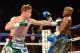 Sep 14, 2013; Las Vegas, NV, USA; Floyd Mayweather Jr. (blue gloves) and Canelo Alvarez battle it during their during their WBC and WBA super welterweight titles fight at MGM Grand Garden Arena. Mandatory Credit: Jayne Kamin-Oncea-USA TODAY Sports