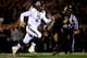 COLUMBIA, MO - NOVEMBER 30: Quarterback Johnny Manziel #2 of the Texas A&M Aggies scrambles as defensive lineman Harold Brantley #90 of the Missouri Tigers chases during the game on November 30, 2013 in Columbia, Missouri. (Photo by Jamie Squire/Getty I