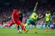 NORWICH, ENGLAND - APRIL 20: Luis Suarez of Liverpool is challenged by Bradley Johnson of Norwich City during the Barclays Premier League match between Norwich City and Liverpool at Carrow Road on April 20, 2014 in Norwich, England. (Photo by Jamie McDo