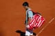 A dejected Novak Djokovic leaves the court after a semifinals loss to Rafael Nadal at the 2013 French Open.