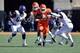 Oct 19, 2013; Stillwater, OK, USA; Oklahoma State Cowboys running back Rennie Childs (23) rushes through Texas Christian Horned Frogs defenders Elisha Olabode (6) and Marcus Mallet (54) during the second half at Boone Pickens Stadium. Oklahoma State won