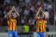 SEVILLE, SPAIN - APRIL 24: Pablo Piatti (R) and Paco Alcacer of Valencia CF applaud their fans after losing 2-0 to Sevilla FC in the UEFA Europa League Semi Final first leg match between Sevilla FC and Valencia CF at Estadio Ramon Sanchez Pizjuan on Apri