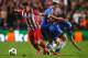 LONDON, ENGLAND - APRIL 30: Cristian Rodriguez of Club Atletico de Madrid takes the ball away from Eden Hazard and Cesar Azpilicueta of Chelsea during the UEFA Champions League semi-final second leg match between Chelsea and Club Atletico de Madrid at St