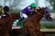 LOUISVILLE, KY - MAY 03: California Chrome #5, ridden by Victor Espinoza, pulls away from Chitu #13, ridden by Martin Garcia, coming out of the fourth turn enroute to winning the 140th running of the Kentucky Derby at Churchill Downs on May 3, 2014 in Lou