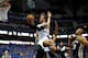 DALLAS, TX - APRIL 28: Monta Ellis #11 of the Dallas Mavericks takes a shot against Tiago Splitter #22 and Patty Mills #8 of the San Antonio Spurs in Game Four of the Western Conference Quarterfinals during the 2014 NBA Playoffs at American Airlines Cent