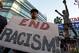 LOS ANGELES, CA - APRIL 29: Dexter McLeod holds a sign protesting racist comments made by L.A. Clippers owner Donald Sterling outside Staples Center before a playoff game on April 29, 2014 in Los Angeles, California. Clippers owner Donald Sterling was