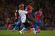 LONDON, ENGLAND - MAY 05: Glen Johnson of Liverpool and Yannick Bolasie of Crystal Palace compete for the ball during the Barclays Premier League match between Crystal Palace and Liverpool at Selhurst Park on May 5, 2014 in London, England. (Photo by Cl