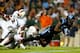 CHAPEL HILL, NC - OCTOBER 17: Teammates Rayshawn Jenkins #26 of the Miami Hurricanes and Deon Bush #2 watch as Eric Ebron #85 of the North Carolina Tar Heels makes a catch during their game at Kenan Stadium on October 17, 2013 in Chapel Hill, North Carol