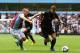 Villa's Ron Vlaar chases down Edin Dzeko.