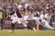 Nov 9, 2013; College Station, TX, USA; Texas A&M Aggies quarterback Johnny Manziel (2) breaks a tackle by Mississippi State Bulldogs defensive back Jamerson Love (5) during the second quarter at Kyle Field. Mandatory Credit: Thomas Campbell-USA TODAY Spor