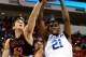 RALEIGH, NC - MARCH 21: Amile Jefferson #21 of the Duke Blue Devils rebounds the ball alongside Daniel Coursey #52 of the Mercer Bears in the first half in the second round of the 2014 NCAA Men's Basketball Tournament at PNC Arena on March 21, 2014 in Ra