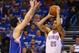 OKLAHOMA CITY, OK - MAY 07: Thabo Sefolosha #25 of the Oklahoma City Thunder takes a shot against J.J. Redick #4 of the Los Angeles Clippers in Game Two of the Western Conference Semifinals during the 2014 NBA Playoffs at Chesapeake Energy Arena on May 7