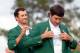 AUGUSTA, GA - APRIL 13: Adam Scott of Australia presents Bubba Watson of the United States with the green jacket after Watson won the 2014 Masters Tournament by a three-stroke margin at Augusta National Golf Club on April 13, 2014 in Augusta, Georgia. (