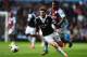 BIRMINGHAM, ENGLAND - APRIL 19: Leandro Bacuna (rear) of Aston Villa chases down Adam Lallana (front) of Southampton for the ball during the Barclays Premier League match between Aston Villa and Southampton at Villa Park on April 19, 2014 in Birmingham,
