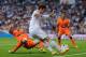 MADRID, SPAIN - MAY 04: Gareth Bale of Real Madrid FC crosses the ball beside Jeremy Mathieu of Valencia CF during the La Liga match between Real Madrid CF and Valencia CF at Santiago Bernabeu stadium on May 4, 2014 in Madrid, Spain. (Photo by Denis Doy