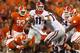 CLEMSON, SC - AUGUST 31: Aaron Murray #11 of the Georgia Bulldogs looks to pass while avoiding being tackled by Grady Jarrett #50 of the Clemson Tigers in the first quarter at Memorial Stadium on August 31, 2013 in Clemson, South Carolina. (Photo by Str