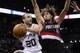 May 8, 2014; San Antonio, TX, USA; San Antonio Spurs guard Manu Ginobili (20) passes the ball under the basket against Portland Trail Blazers center Robin Lopez (42) in game two of the second round of the 2014 NBA Playoffs at AT&T Center. The Spurs won 11